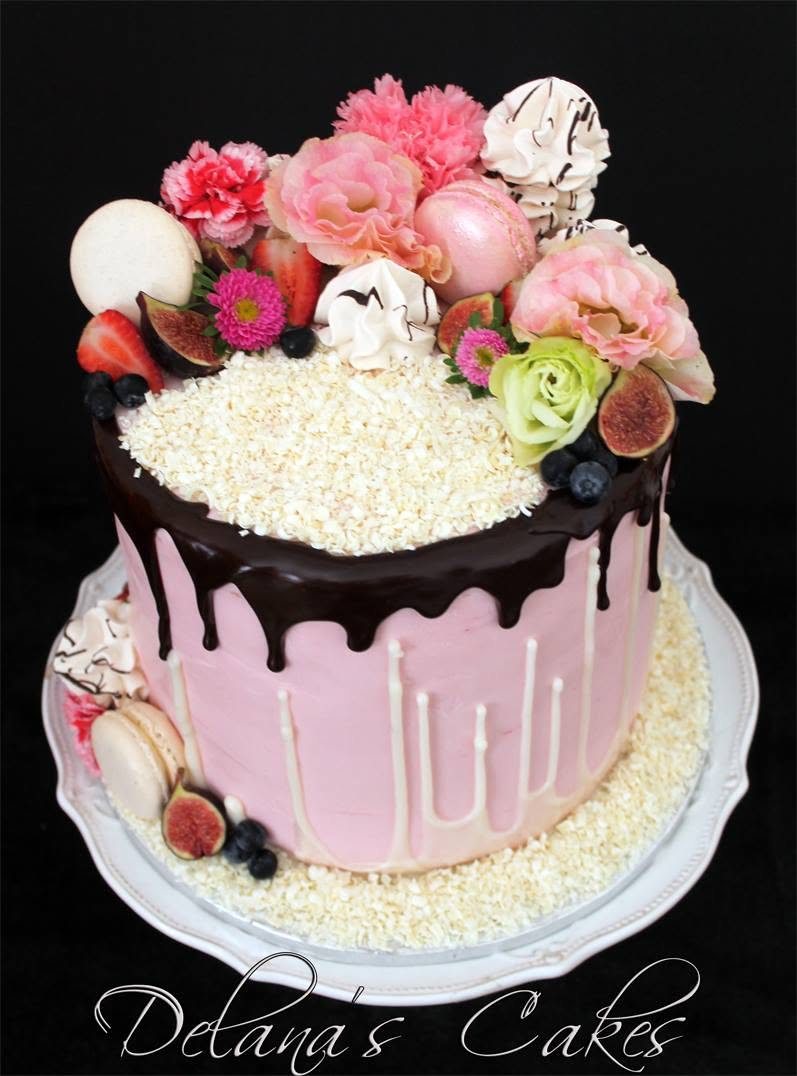 Round cake with pink flowers and drip detail
