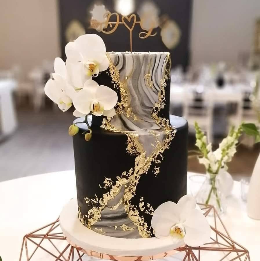 Black and gold event cake with orchids
