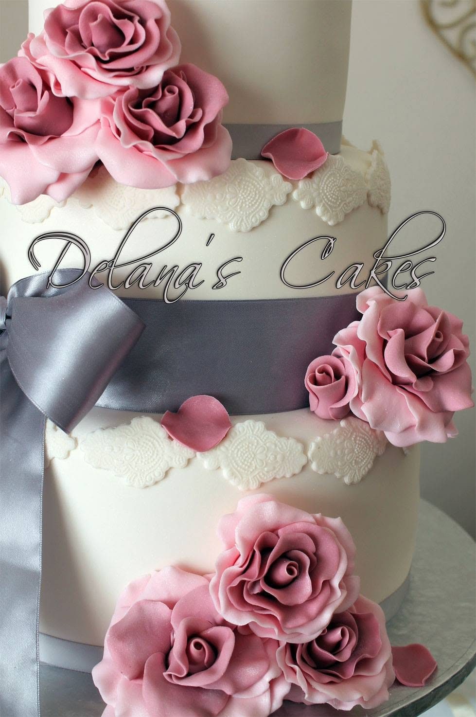 Close-up of cake roses and Delana's Cakes branding