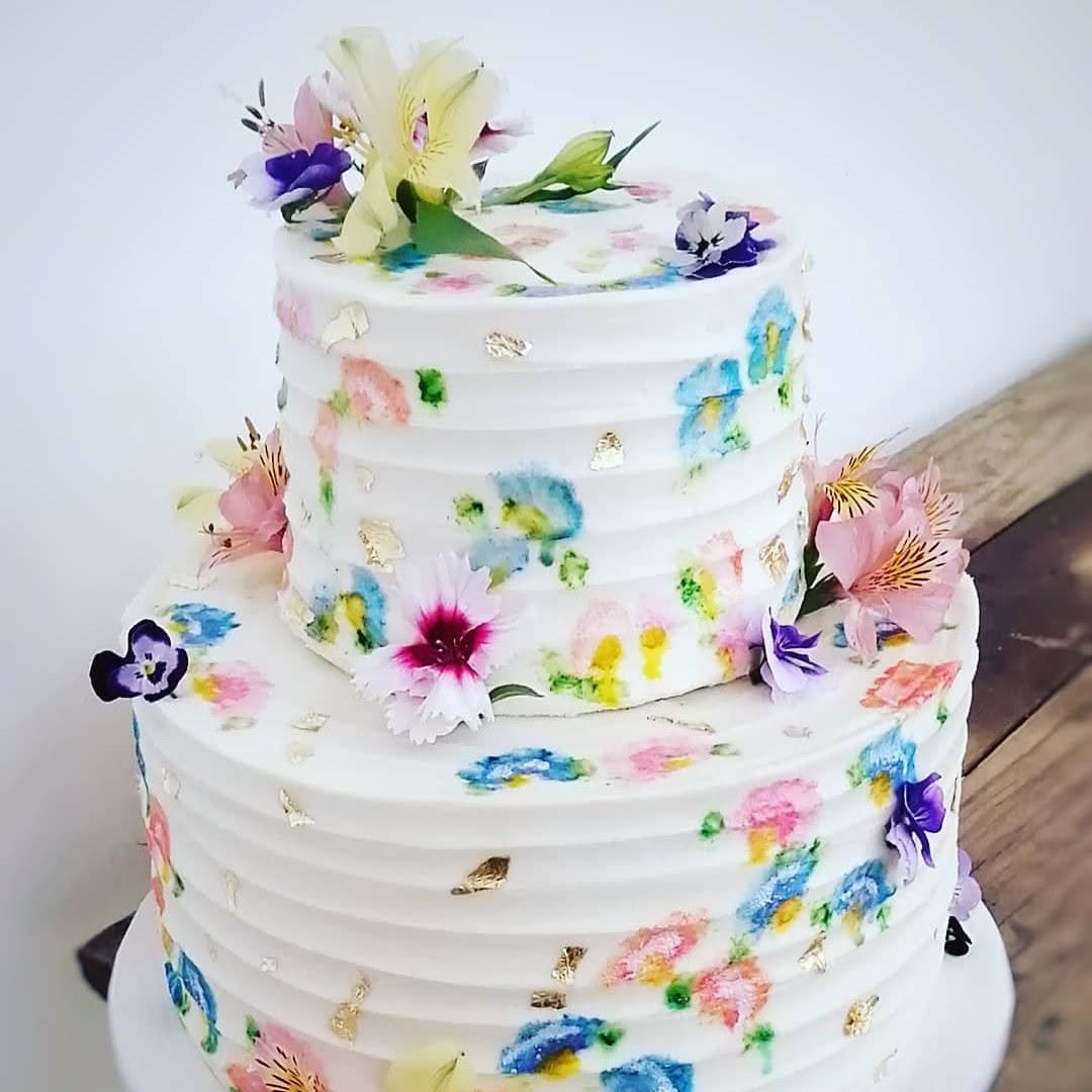 White celebration cake with painted floral details